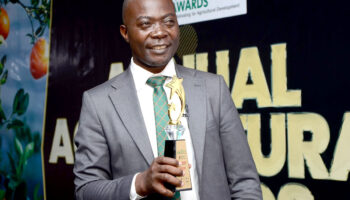 Dr. Kabanda David, CEFROHT Executive Director, proudly holds the Food Systems Award, recognizing his leadership in promoting sustainable food rights and agroecology in Uganda.